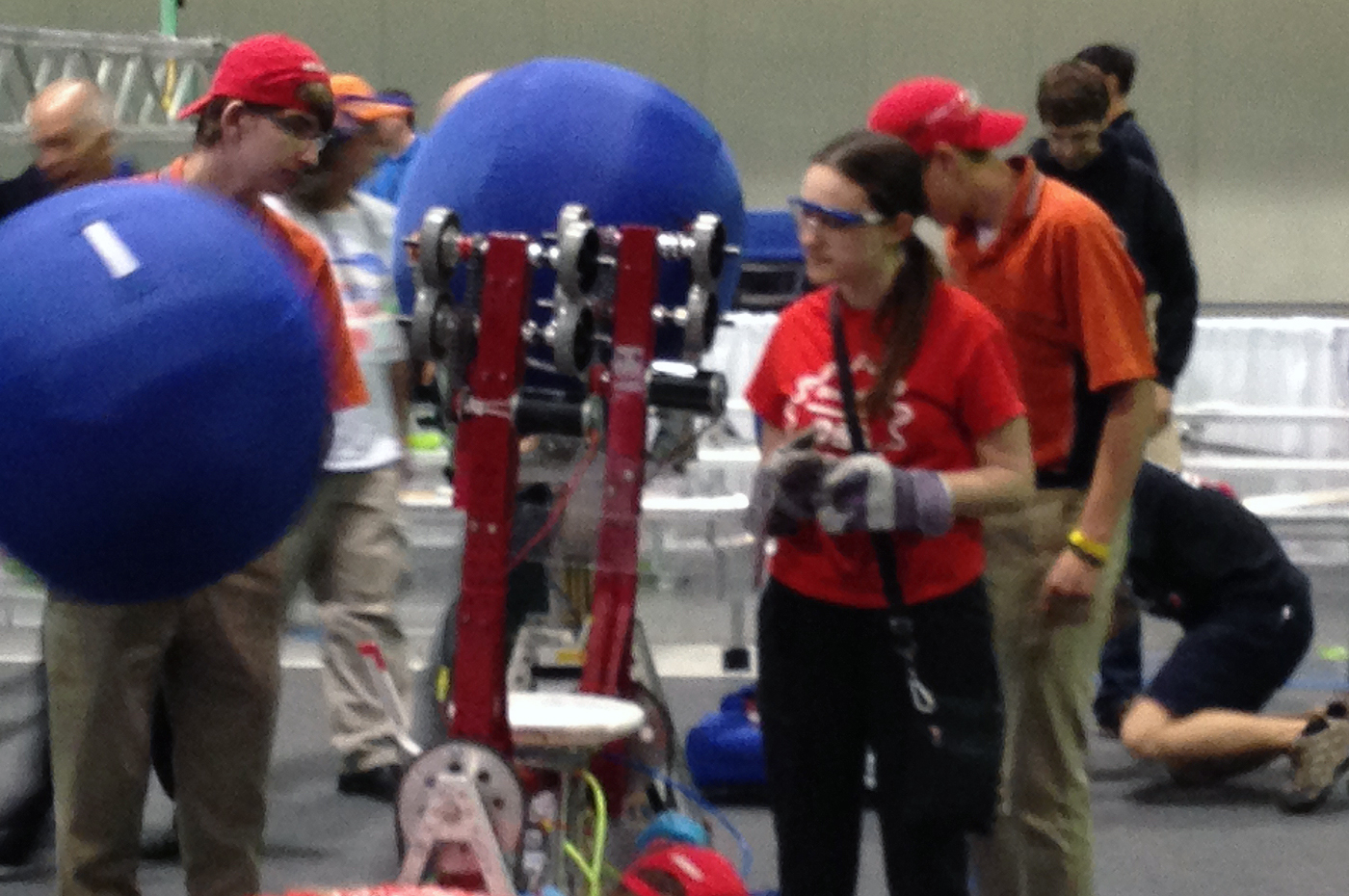 Teammates making last-minute adjustments to their robot.