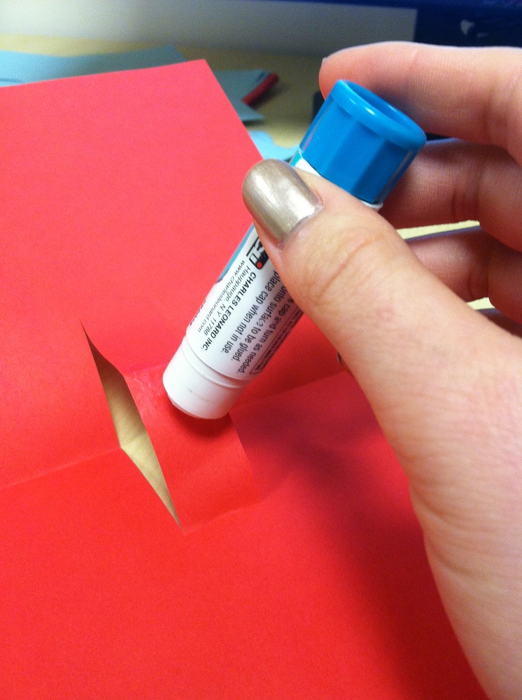 6. Next, apply glue to the tab and paste your illustration onto the area where the adhesive has been applied.