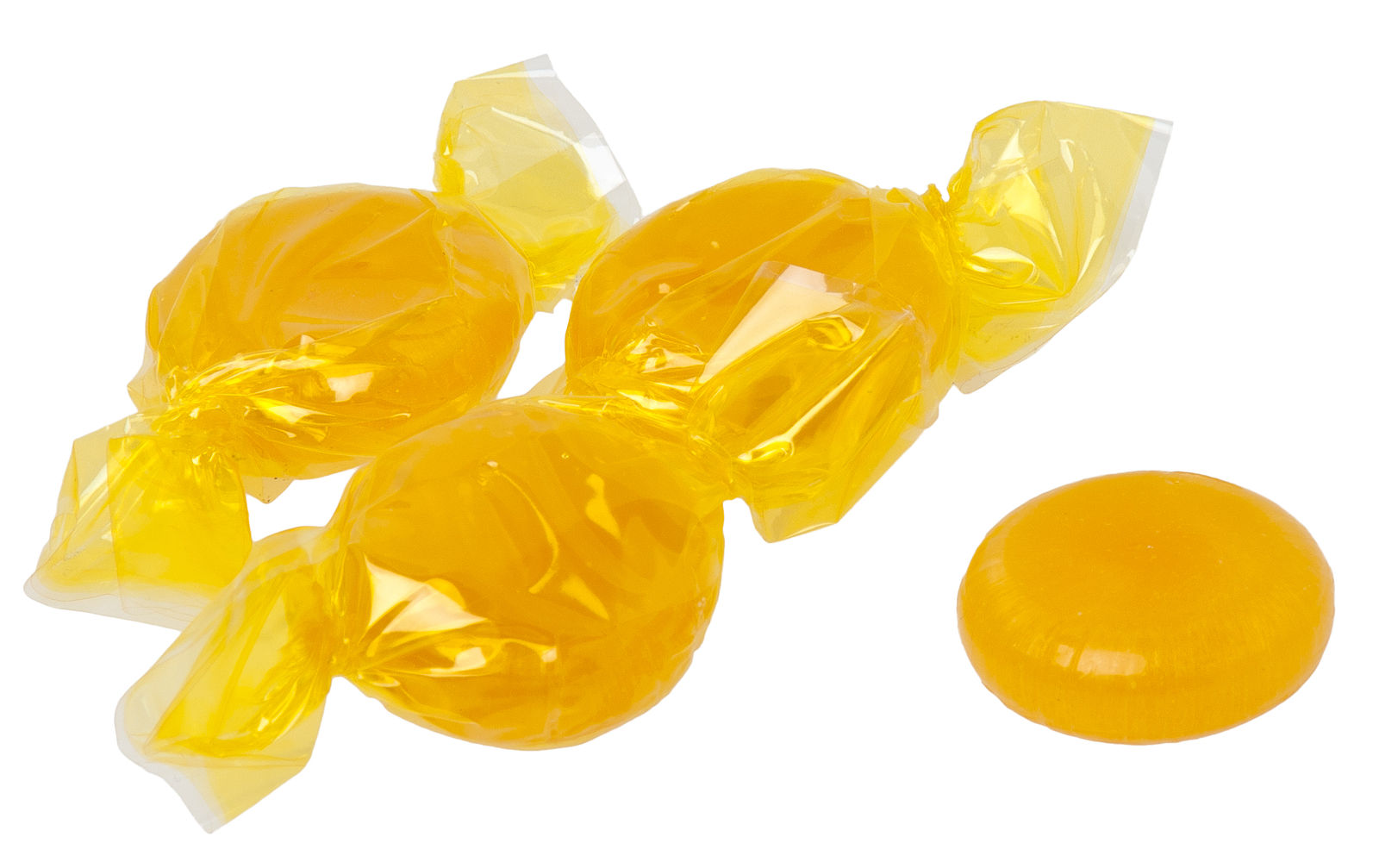 A photograph of hard candies in a vivid yellow color on a white surface.