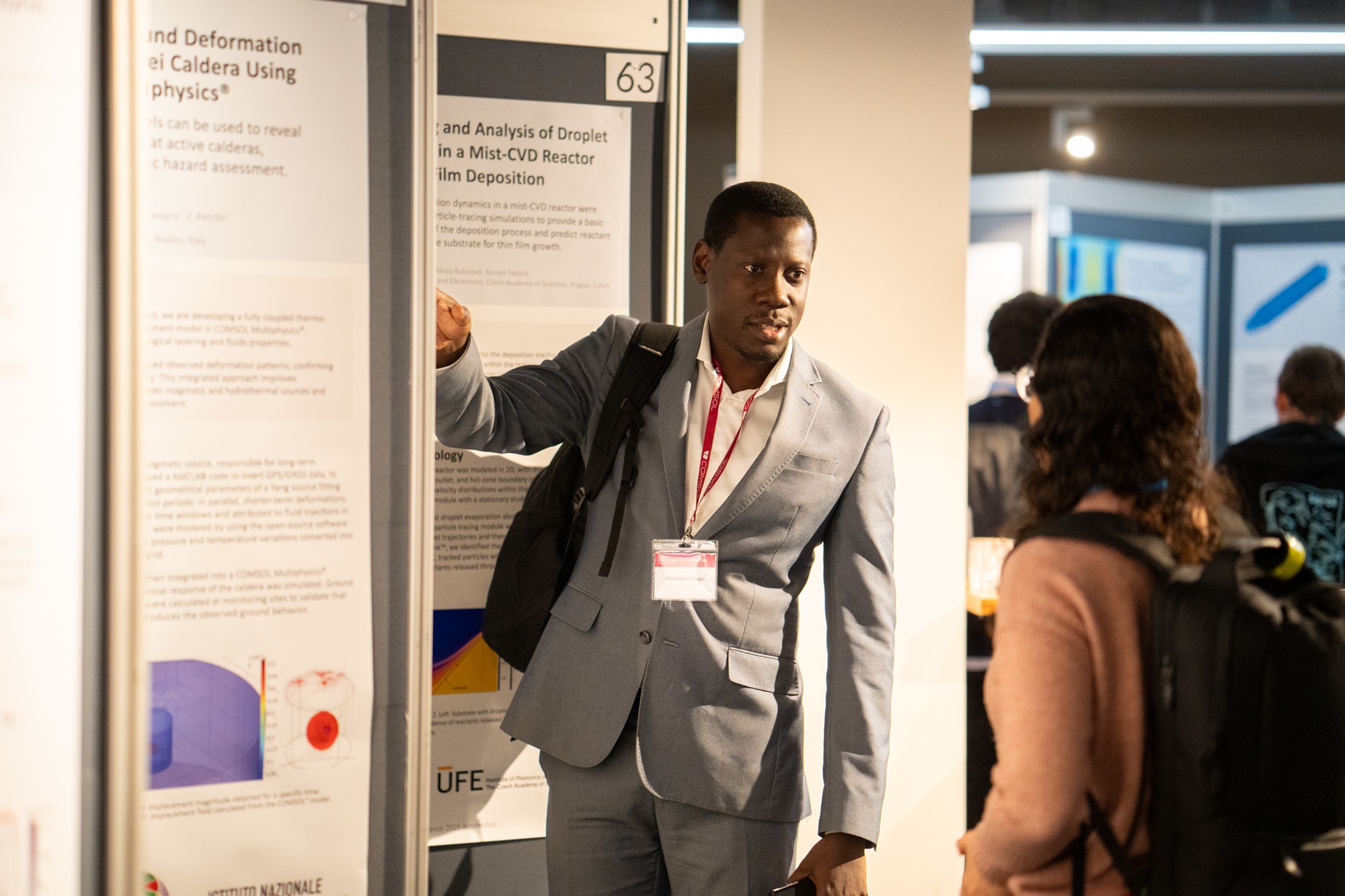 A conference attendee presenting their poster.