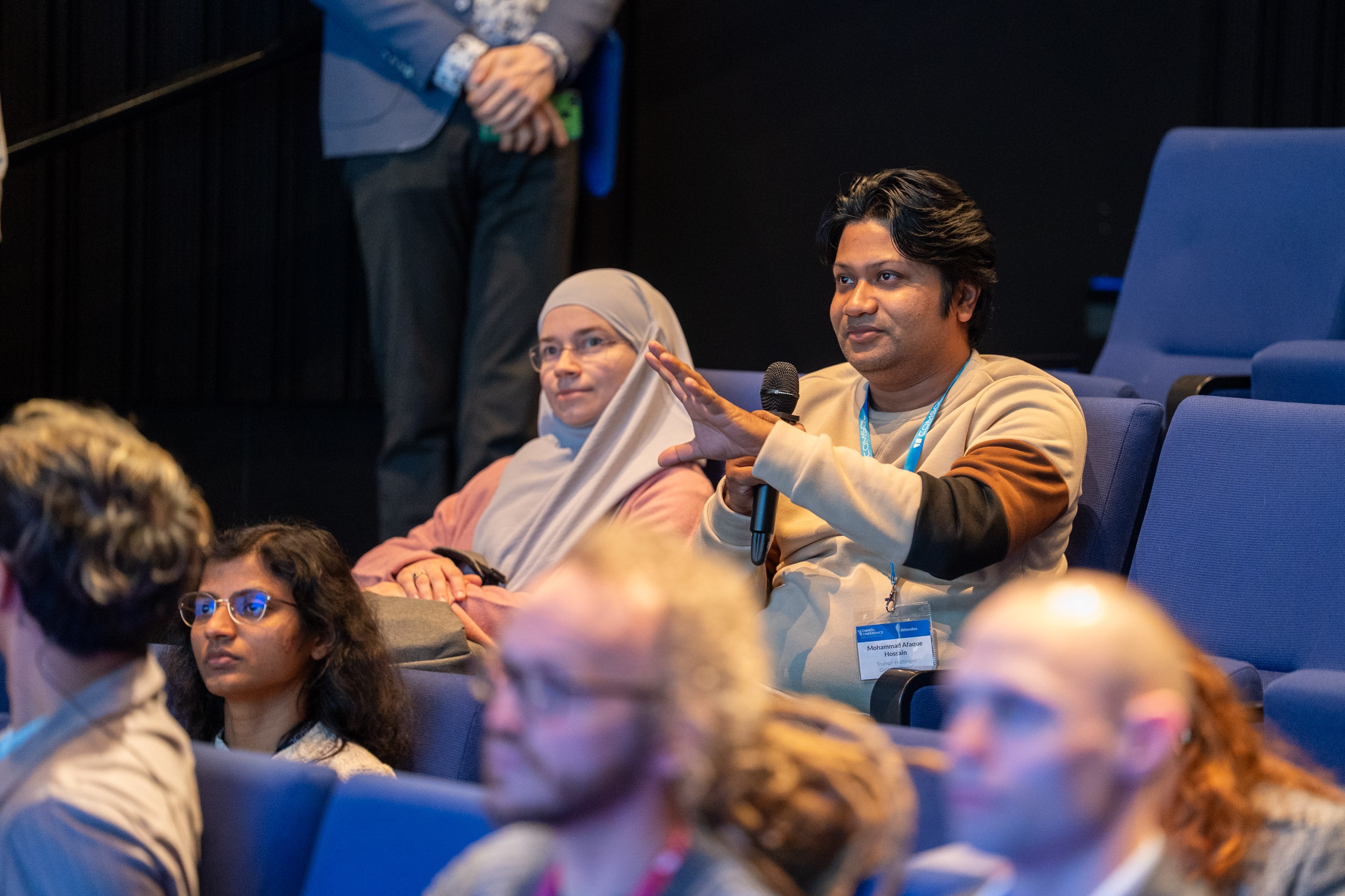 An attendee asking a question during a presentation.