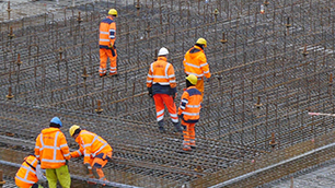 Construction workers wearing high-vis gear and hardhats.