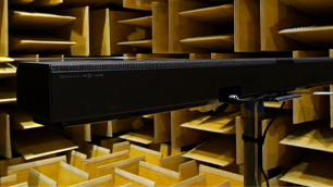 A black soundbar inside an anechoic chamber.