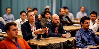 Six COMSOL Conference attendees partake in a discussion during a minicourse.