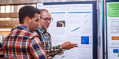 COMSOL Conference attendees and poster presentations in the conference's poster hall.