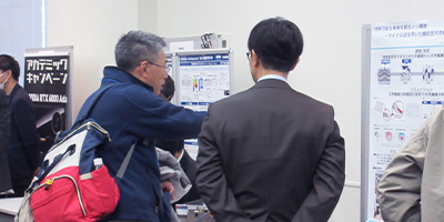 COMSOL Conference attendees and poster presentations in the conference's poster hall.