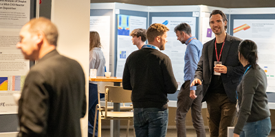 COMSOL Conference attendees and poster presentations in the conference's poster hall.