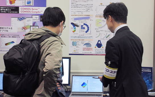 COMSOL Conference attendees having a conversation in the exhibition hall.