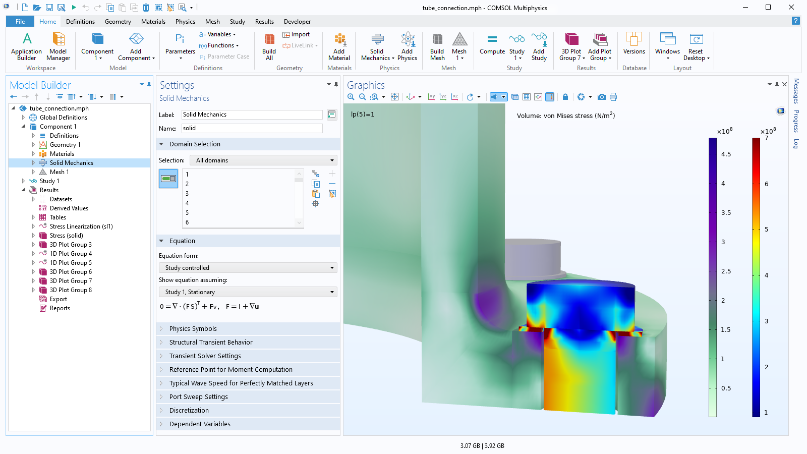 The COMSOL Multiphysics UI showing the Model Builder with the Solid Mechanics node highlighted, the corresponding Settings window, and a tube connection model in the Graphics window.