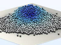 Detailansicht eines Körnerhaufens, dessen Farbe von dunkelblau oben zu grau unten übergeht.