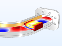 A model of a waveguide bend that is partially transparent to reveal a red-white-and-blue surface plot representing the wave traveling through and a dielectric block with temperature shown in red, yellow, and white color gradient.