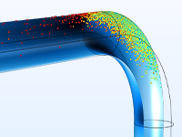 A close-up view of a pipe elbow model showing the velocity in particles.