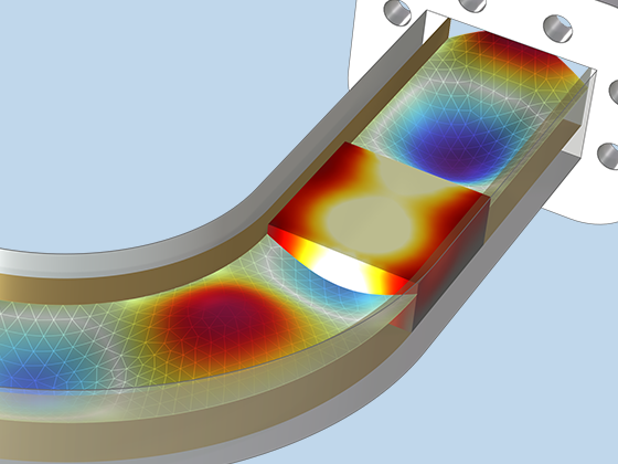 A closeup view of a wave traveling through a waveguide bend and a dielectric block heating up.