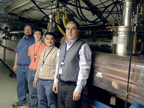 Photograph of Fermilab engineers in the Booster tunnel