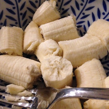 A bowl of bananas ready to be mashed for banana bread.
