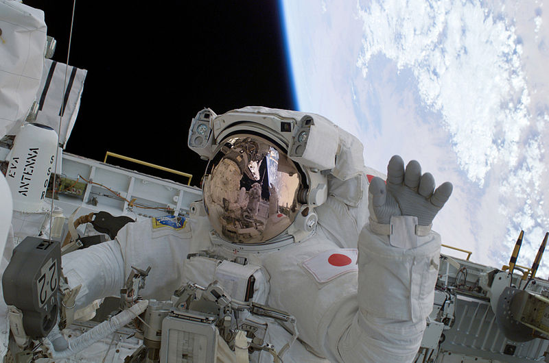 Photograph of an astronaut in a spacesuit that appears inflated.