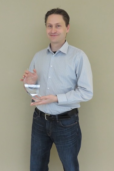 A photo of Bjorn Sjodin with the award.