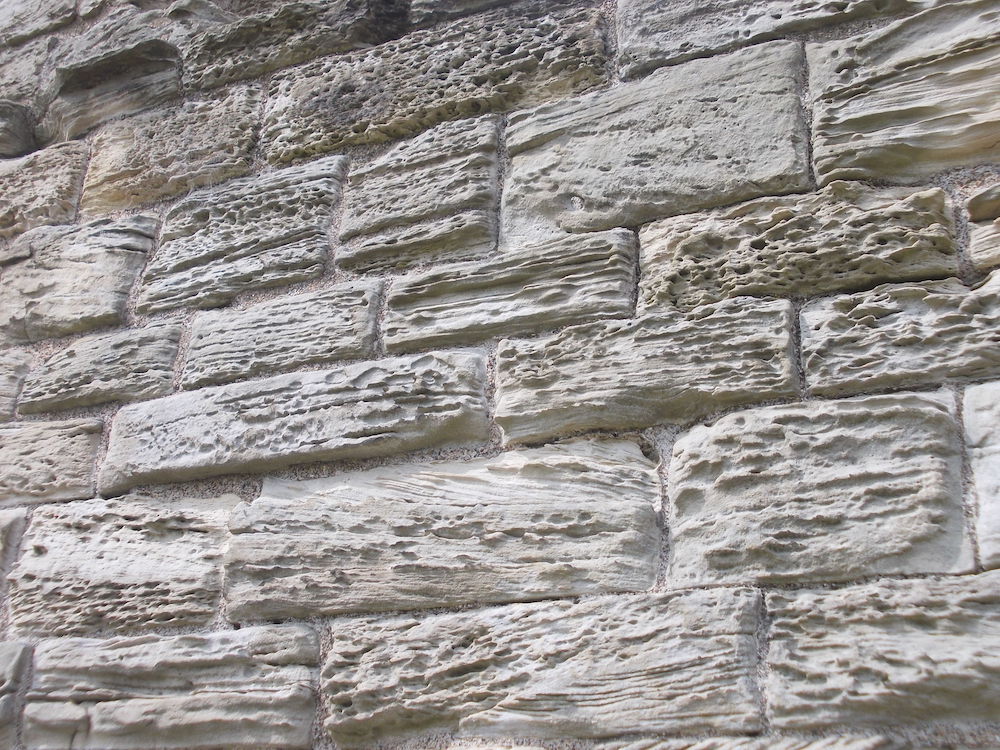 A photograph showing salt damage to a wall.