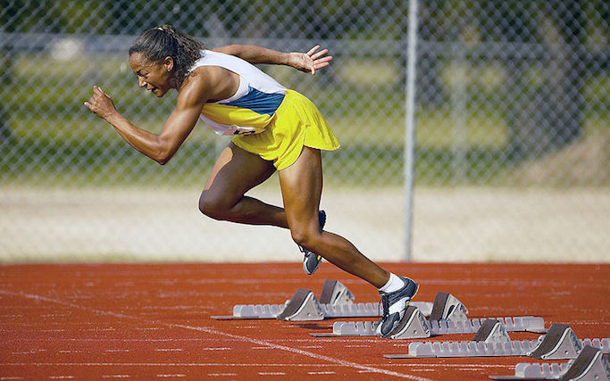 A woman running on a track.