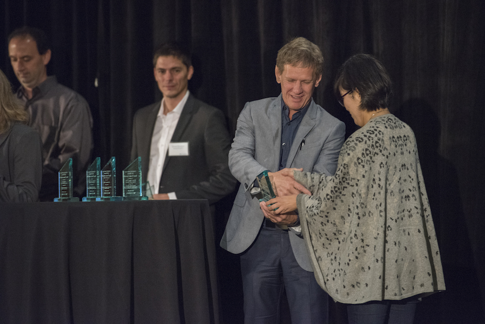 Photo showing an award being given out at the COMSOL Conference.