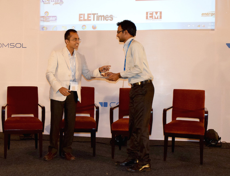 A photograph of Sai Pavan accepting the award for Popular Choice Poster.