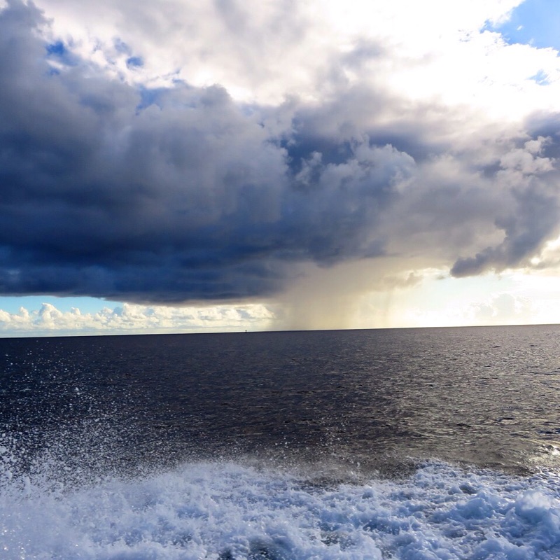 A rain cloud amidst a sunny sky illustrates the unpredictable nature of weather.