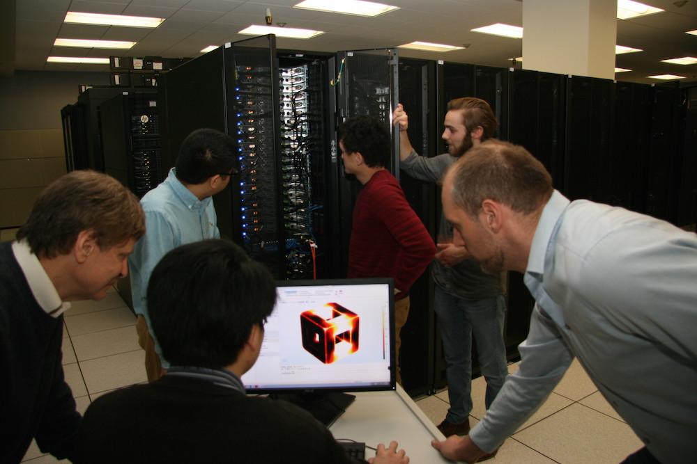 Photograph of Ed Furlani and his graduate students at University of Buffalo building models and apps.