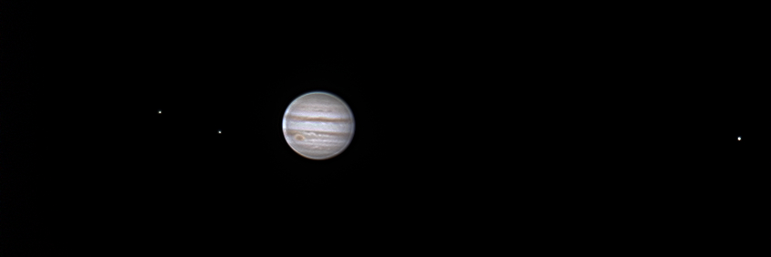 A picture of Jupiter and three of its moons.