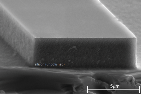 A scanning electron micrograph that shows an unpolished silicon-on-insulator rib waveguide used for magneto-optic routers.