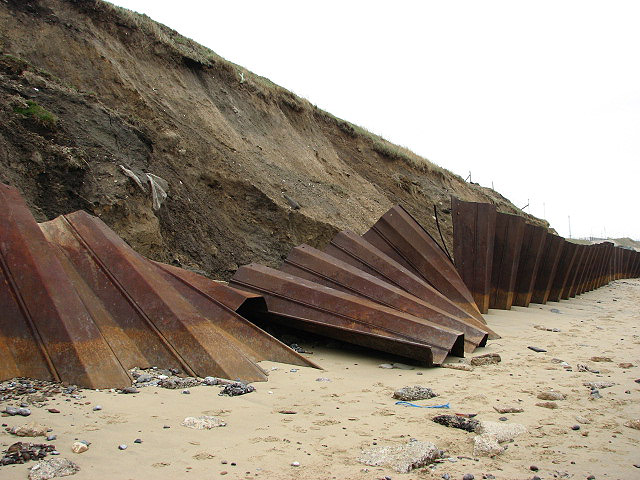 A photograph of a steel sheet piling that has been partially disrupted.