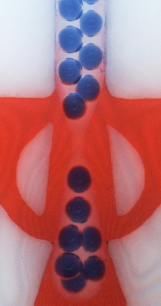 A zoomed-in photograph showing a bat-wing junction, a novel fluidic junction.