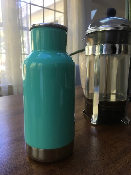 A photo of a vacuum flask filled with hot coffee.