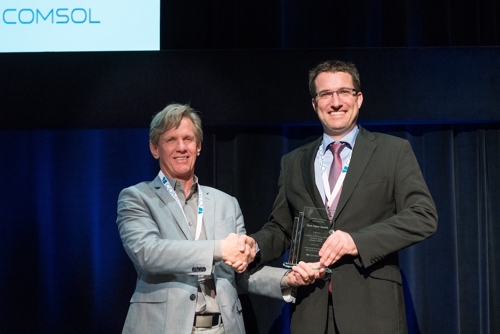 A photograph of J. Schüttler and Svante Littmarck at the conference awards ceremony in Rotterdam.