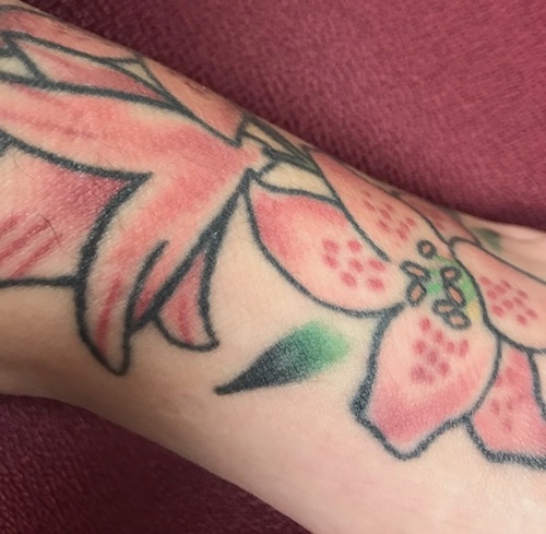 Lily tattoos featuring green ink.
