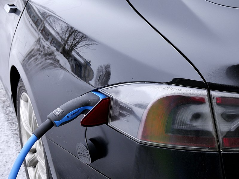 A close-up photo of an electric vehicle charging.