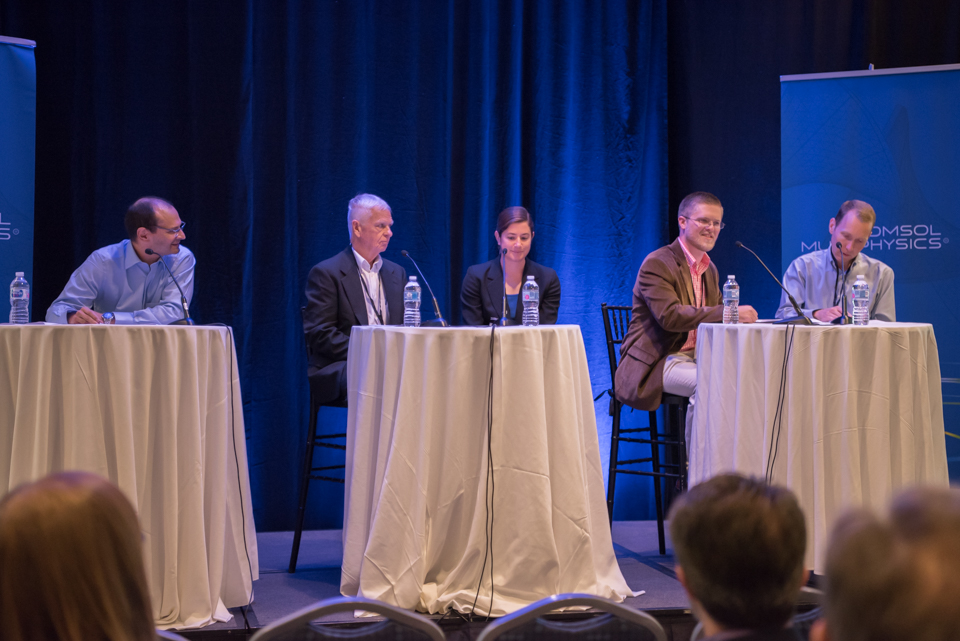 A photograph of a panel discussion at the COMSOL Conference.