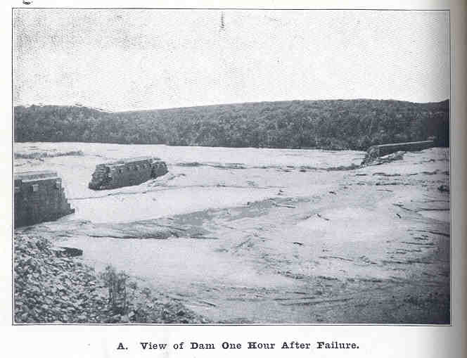 A black-and-white image of the damage caused by a dam failure.