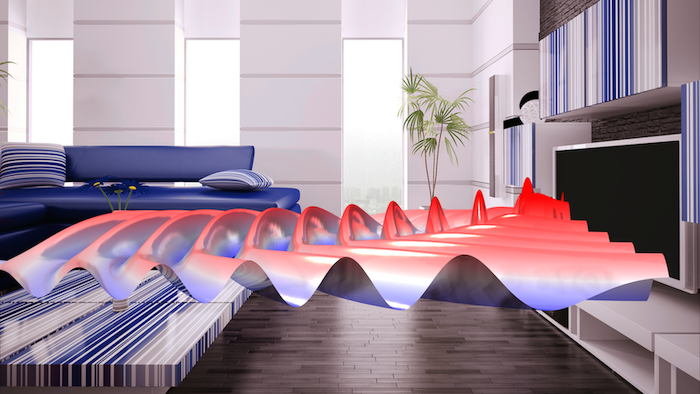 A virtually augmented living room, with a plot of the radiation pattern of a loudspeaker coming from a TV, visualized in reds and blues.