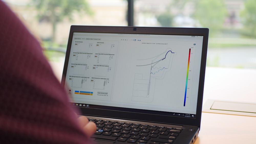 A photograph of a transducer engineer using a simulation application.