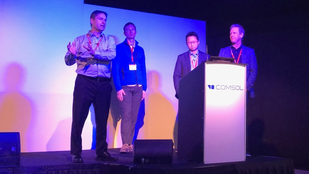 A photograph of Svante Littmarck, Bjorn Sjodin, Kristian E. Jensen, and Jiyoun Munn at the COMSOL Conference 2019 Cambridge.