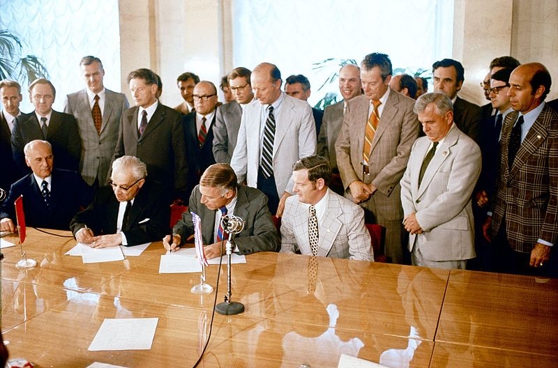 A photograph of Vladimir Kotelnikov signing the ASTP agreement.