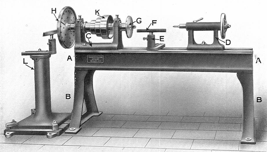 A black and white photograph of a lathe.