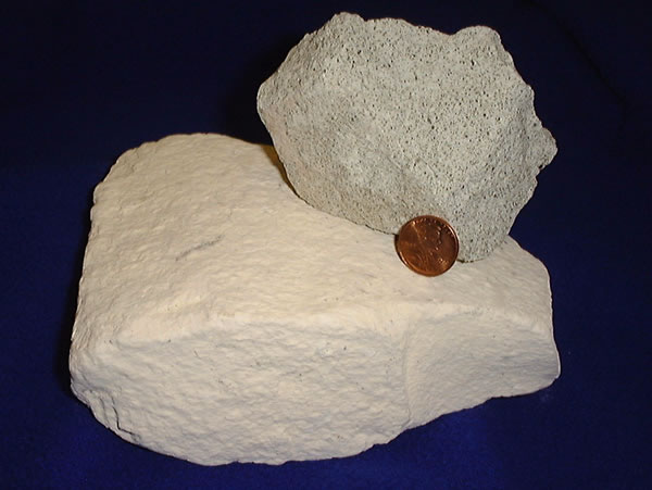 Natural zeolite, which can form molecular sieves, shown in a photograph next to a penny for scale.