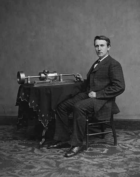 A black-and-white photograph of Thomas Edison with a phonograph.