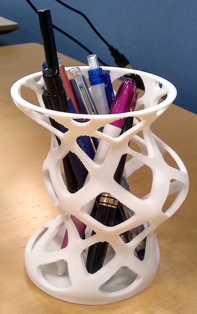 A photograph of a 3D printed pencil holder that was produced via generative design.