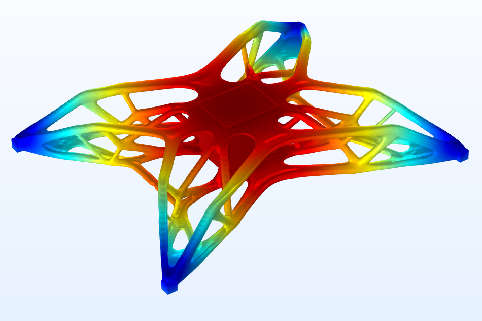 A model of a drone after performing a topology optimization study, with the simulated displacement visualized in a rainbow color table.