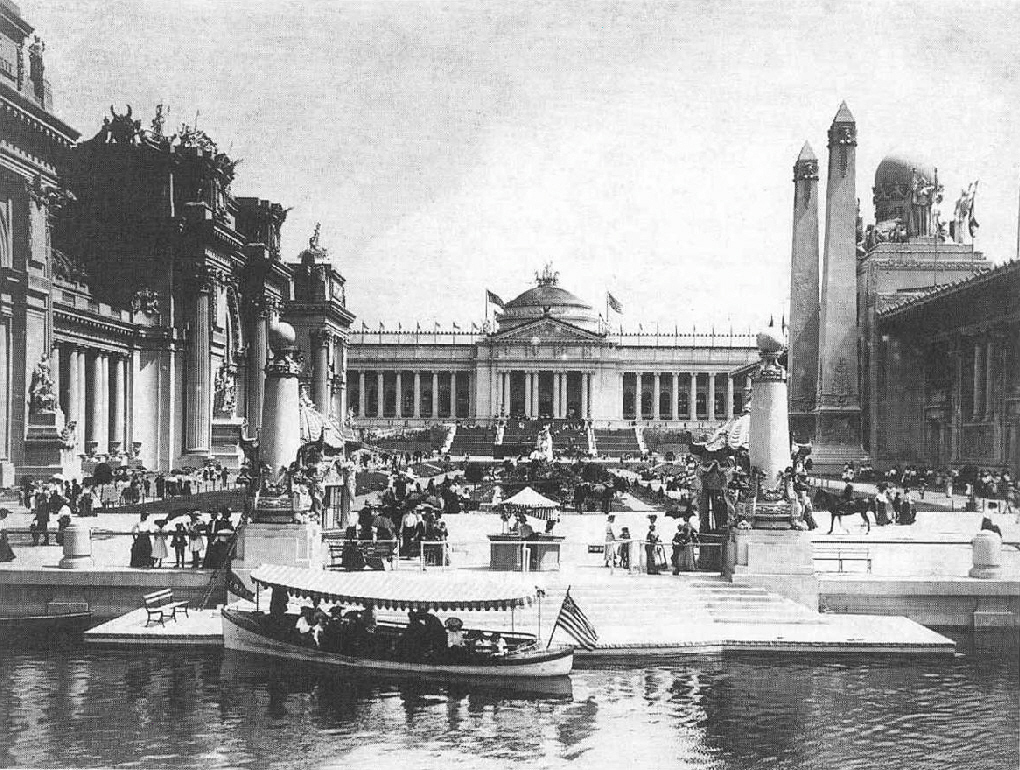 A black-and-white photo of buildings along a waterway at the 1904 St. Louis World's Fair.