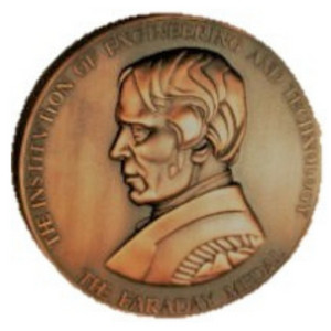 A front view of the Faraday Medal, which features a profile view of Micheal Faraday.