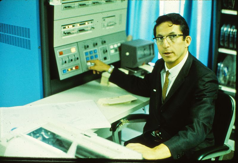 A photograph of Robert Ledley sitting at a desk.