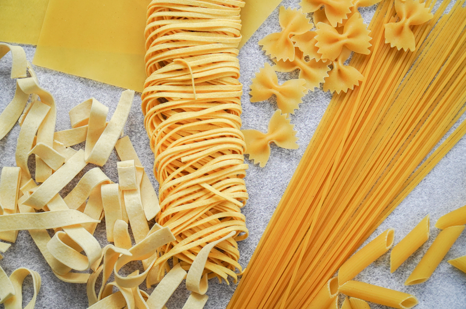 A close-up of dry pasta of varying shapes and sizes.